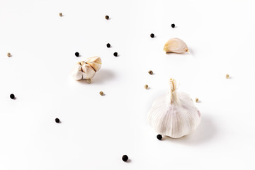 Garlic, black pepper and white pepper as spices for cooking On a white background