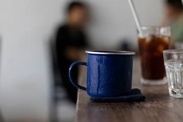 cup of coffee metal blue cup in a coffee shop