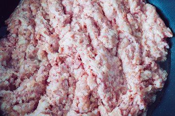 Raw minced meat in a frying pan.  Cooking minced meat  on frying pan. 