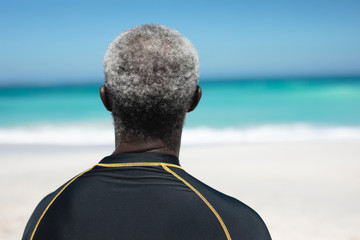 Old man looking at the waves