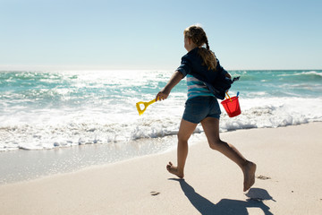 Girl playing at the beach