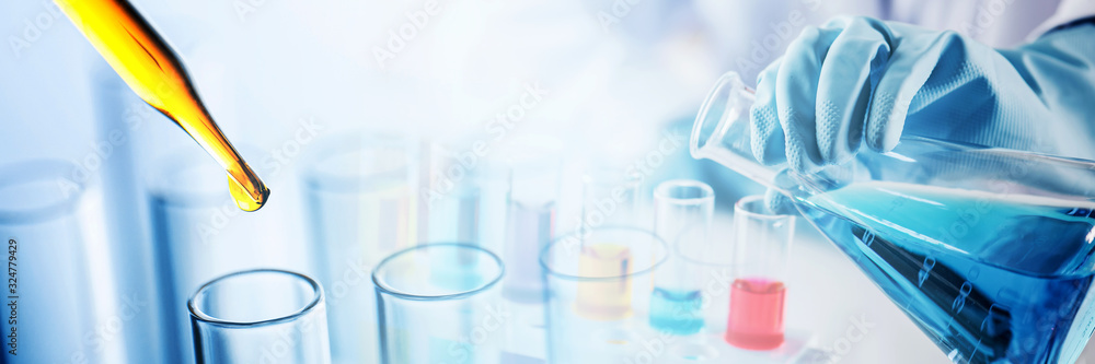 Poster hand of scientist holding flask and pouring sample to test tube with dropping yellow liquid to test 