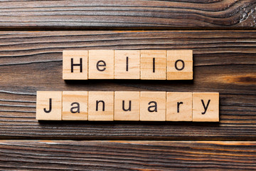 hello january word written on wood block. hello january text on table, concept