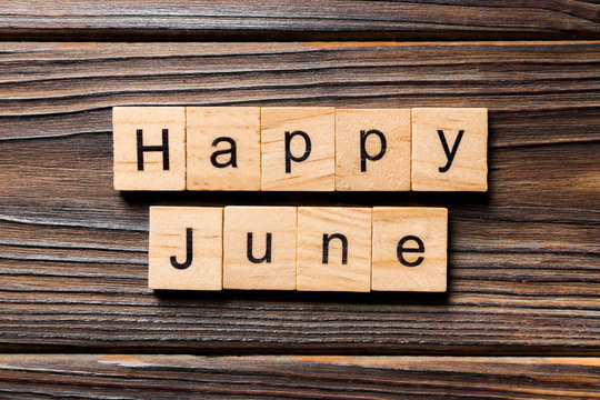 Happy June word written on wood block. Happy June text on table, concept