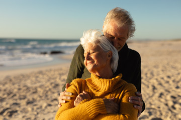 Old couple in love at the beach