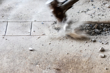 A large hammer bashed into the concrete.