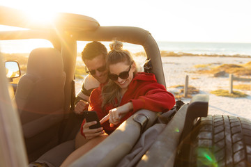 Couple with a car enjoying free time