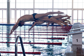 Swimmers plunging in the pool
