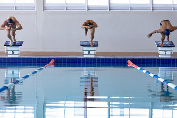 Swimmers plunging in the pool