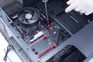 Hands of a technician assembling computer hardware parts new cpu is being mounted unto the...