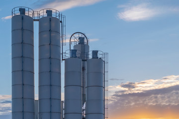 Concrete factory. Cement factory on a cloudy sky background.