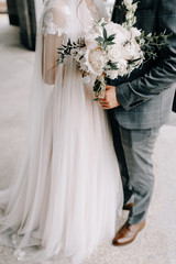 Elegant wedding couple. Bride and groom embracing at wedding day