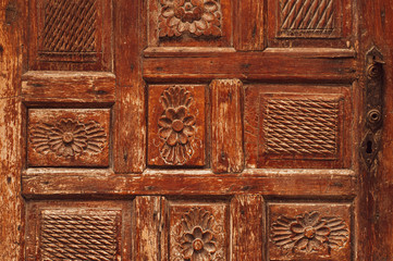 Fragment of a wooden antique door. The streets of Turkey. Background photo.