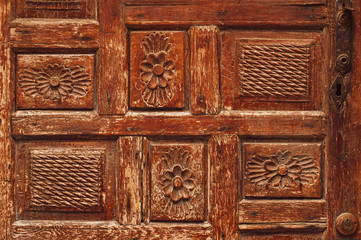 Fragment of a wooden antique door. The streets of Turkey. Background photo.