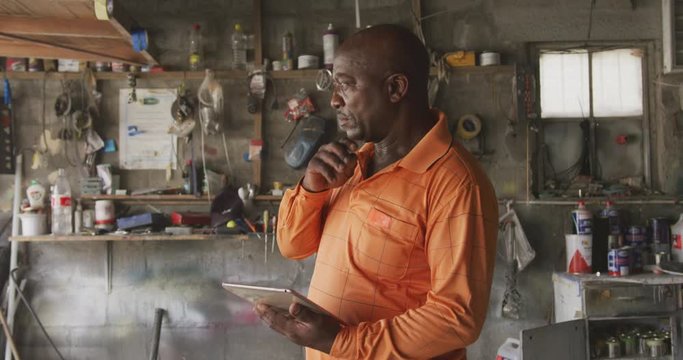 Thoughtful African man at work