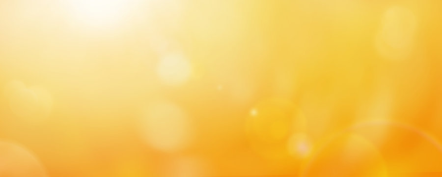 Bright yellow and gold bokeh summer sun abstract sky background.