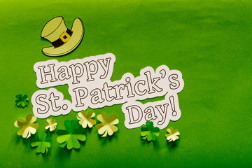 Saint Patrick's day background with hat and paper clovers