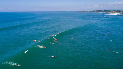 Aerial view of Canggu beach with surfers on Canggu beach located in the west of Bali