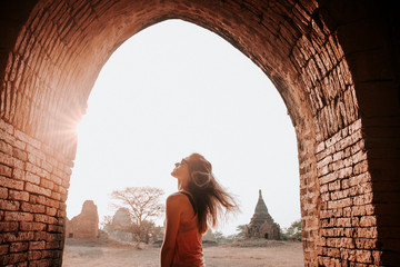 Young Woman enjoying an amazing sunset in Bagan - obrazy, fototapety, plakaty