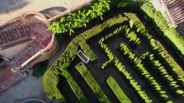 very smooth drone footage of the romantic plant labyrinth in Barcelona tilting up and flying backwards