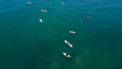 Aerial view of Canggu beach with surfers on Canggu beach located in the west of Bali