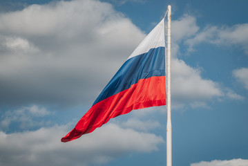 Limp Russian flag on the background of blue sky,
