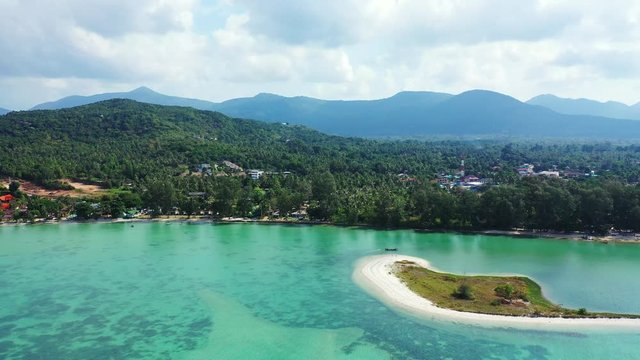 Beautiful touristic villages in the middle of tropical forest bordered by exotic beach and calm turquoise lagoon around a tiny island, Ko Phangan