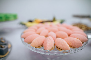 Sweet food. Delicious pink cakes on dessert table in restaurant