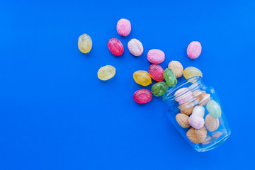 Colorful candies on blue background, stock photo
