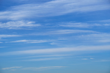 Fototapeta premium Bright beautiful blue sky with soft clouds for background or texture