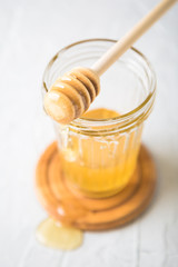 Natural flower honey in a glass jar