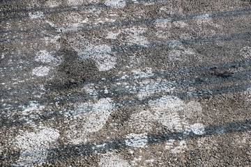 Abstract winter weather background. Winter concept. Winter walk. Salt footprints on asphalt. Deicing chemicals concept.