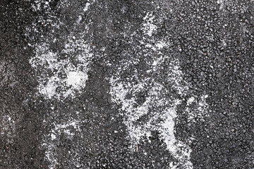De-icing chemicals on the asphalt pavement. Pavement is sprinkled with technical salt or salt mixtures based on it.