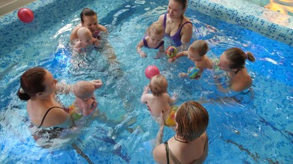 Children with their moms in the pool