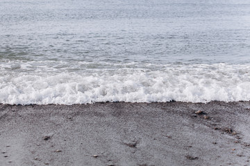 Waves on the beach. A surge of water ashore.