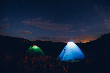 Tents in the night with the milky way.  Wanderlust and travel concept. 
