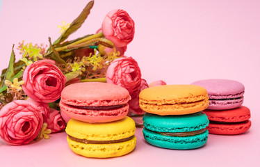 Obraz na płótnie Canvas macarons with tender small roses. Sweets and desserts concept of macaroons