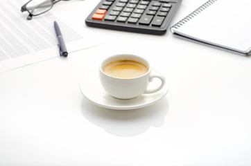 Accounting business concept. Desktop with cup of coffee, calculator, glasses, notepad and spreadsheet.
