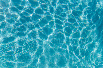 Fototapeta na wymiar Beautiful refreshing blue swimming pool water. Background of blue water in the pool