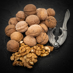 Lot of whole ripe brown walnut  on black