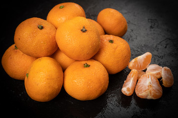 Juicy mandarin on  black background. Mandarin Fruit
