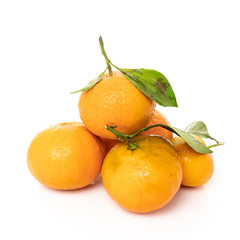 Ripe mandarines with leaves close-up on a white background