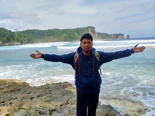 Young man on the beautiful beach