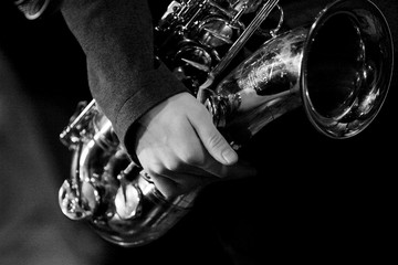Hands of tenor saxophone player on the stage - obrazy, fototapety, plakaty