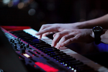 Keyboard player hands on the stage 
