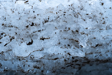 Melting snow with ice hummocks background. Spring background. Nature winter landscape. Melting glacier. Global warming concept.