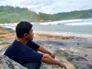 Young man on the beautiful beach