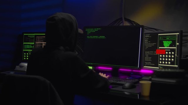Female hacker breaks into a computer in a dark room