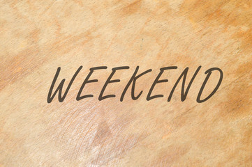 Fototapeta na wymiar weekend word written on wooden background