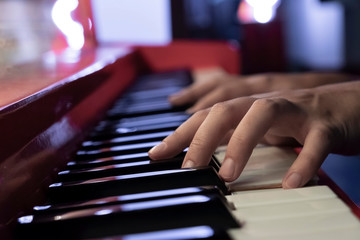 Fototapeta na wymiar Woman's hands on the keyboard of the piano closeup. Hands musician playing the piano closeup.